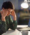 A stressed woman sitting by her desk